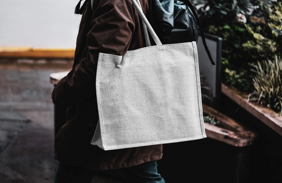 Eco Bag Carrying by Man Mockup PSD Presentation