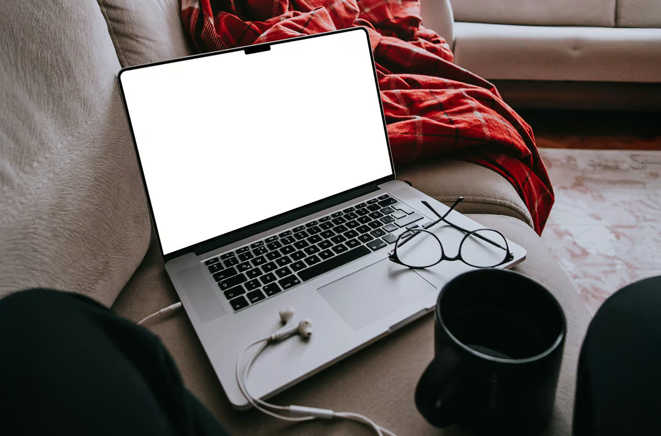 MacBook Pro Laying on Couch PSD Mockup